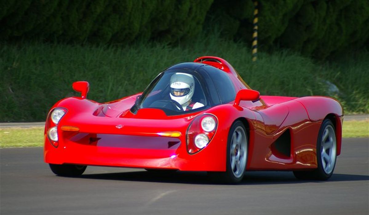 Red Yamaha OX99-11 being driven down road