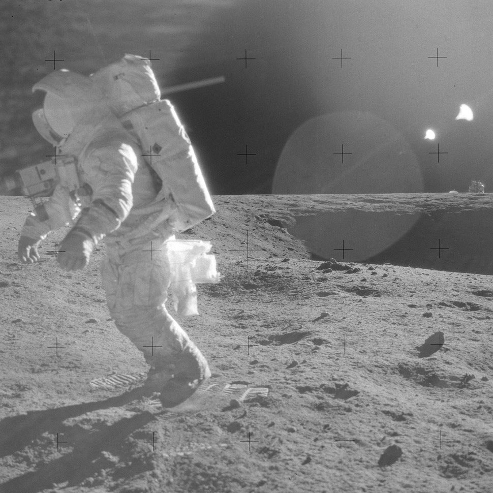 Alan Bean traversing the Lunar Surface. LM in background.