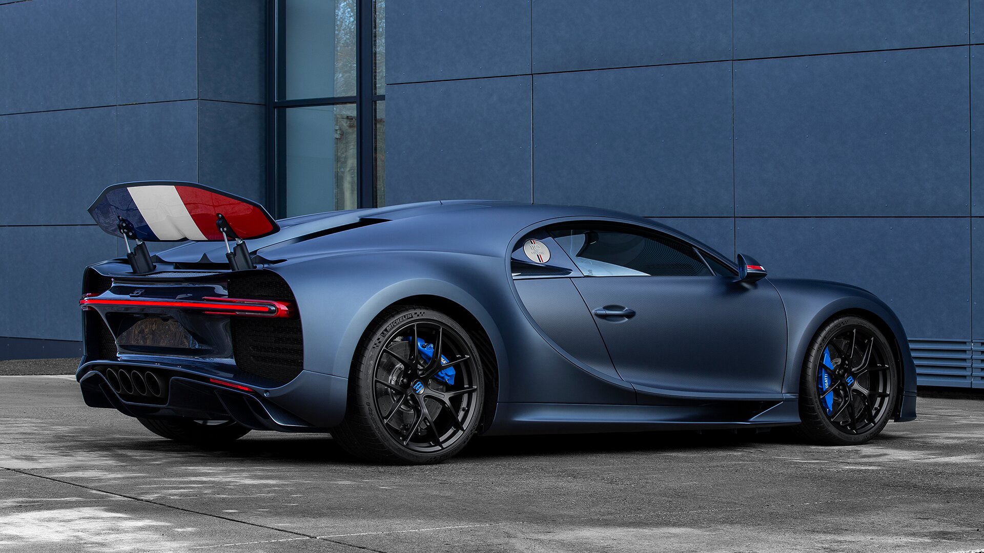 Blue Bugatti Chiron Sport 110 Ans Edition outside garage