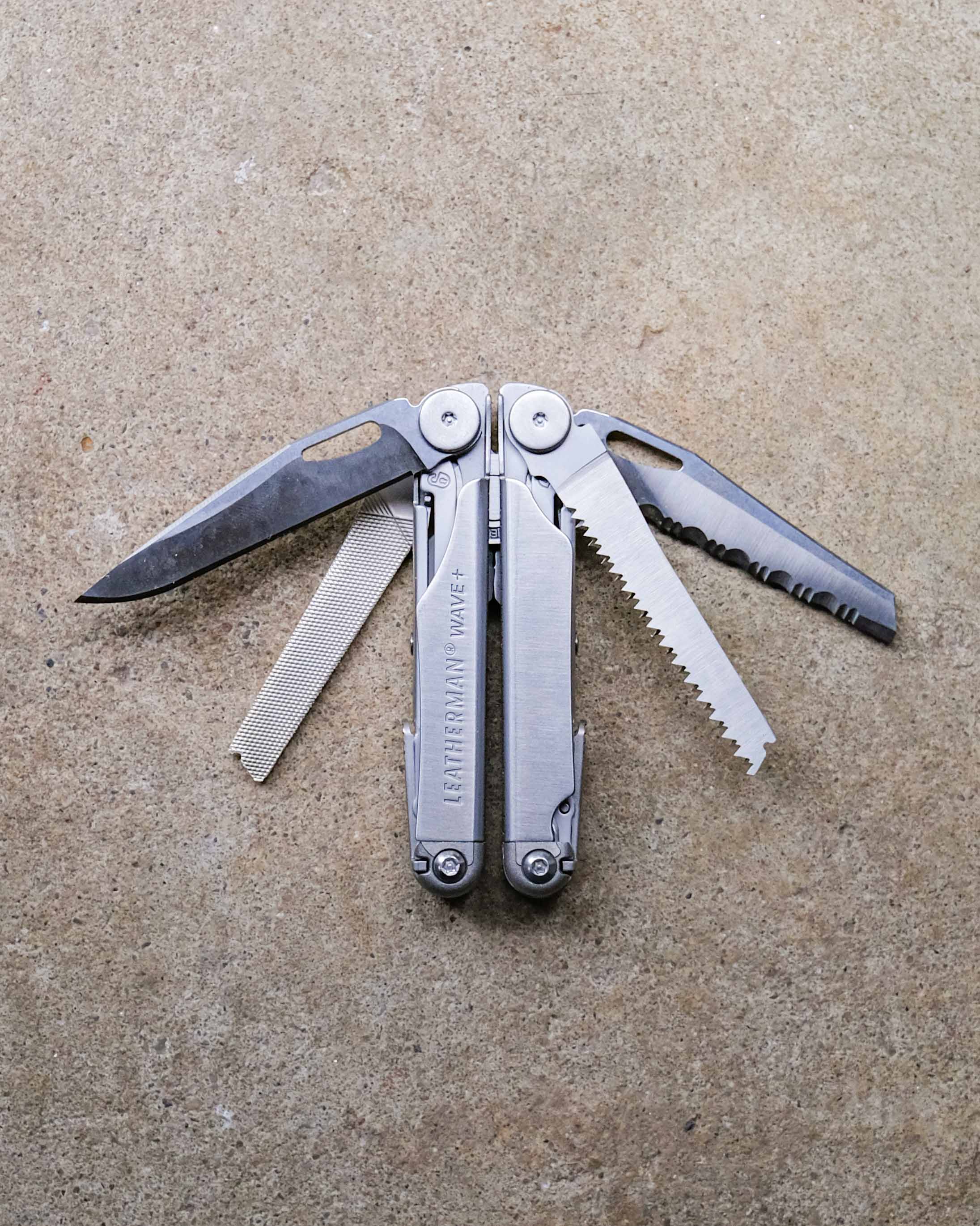 Leatherman multi-tool on concrete backdrop